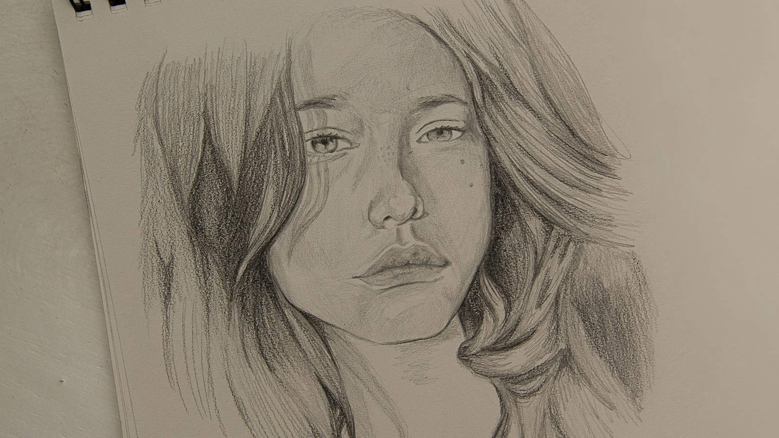 womans face sketch on white paper