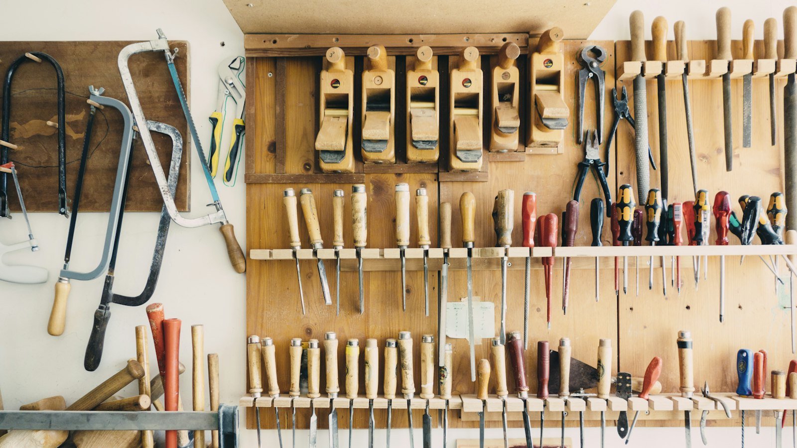 assorted handheld tools in tool rack