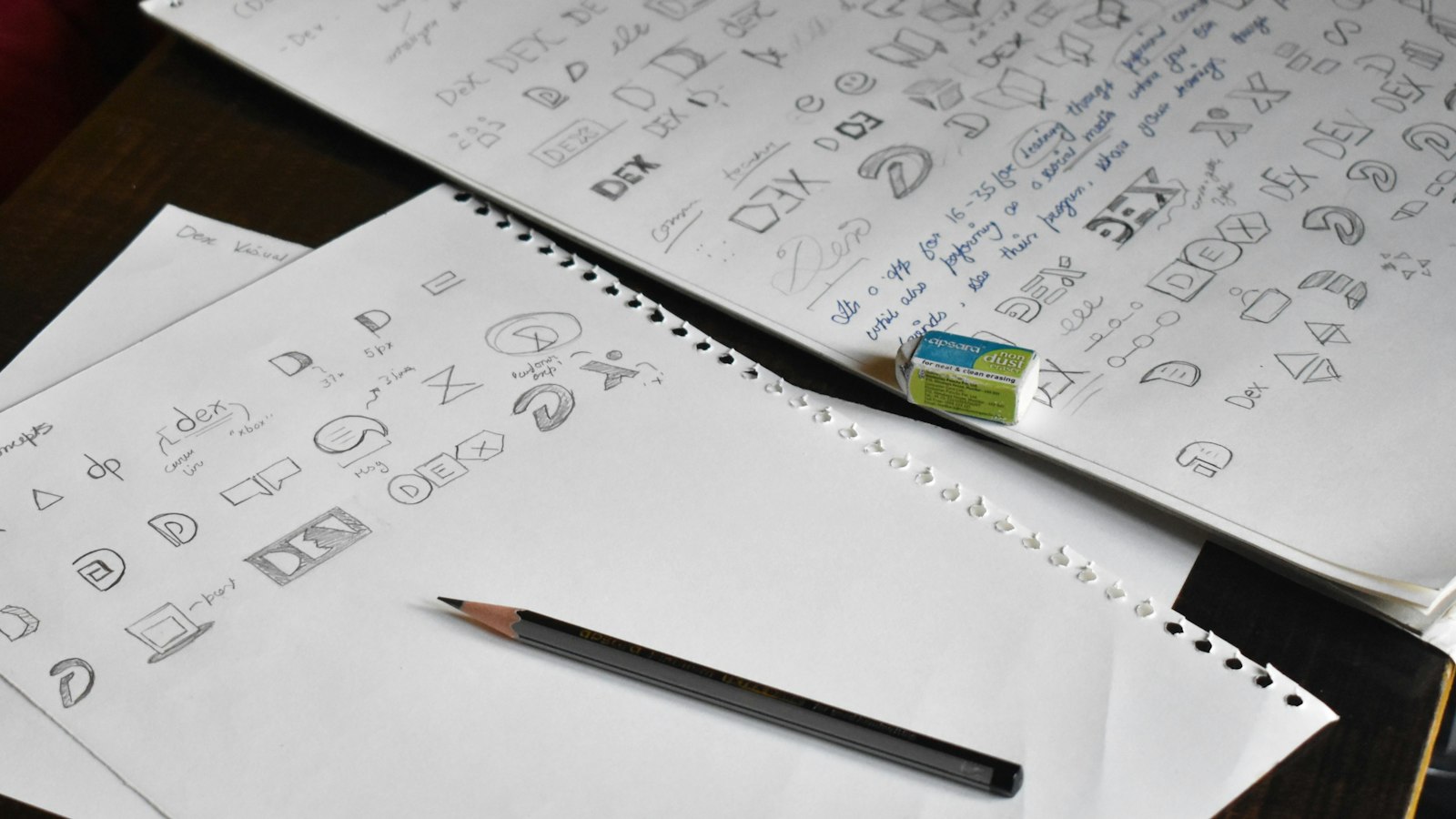 a pencil sitting on top of a pile of paper