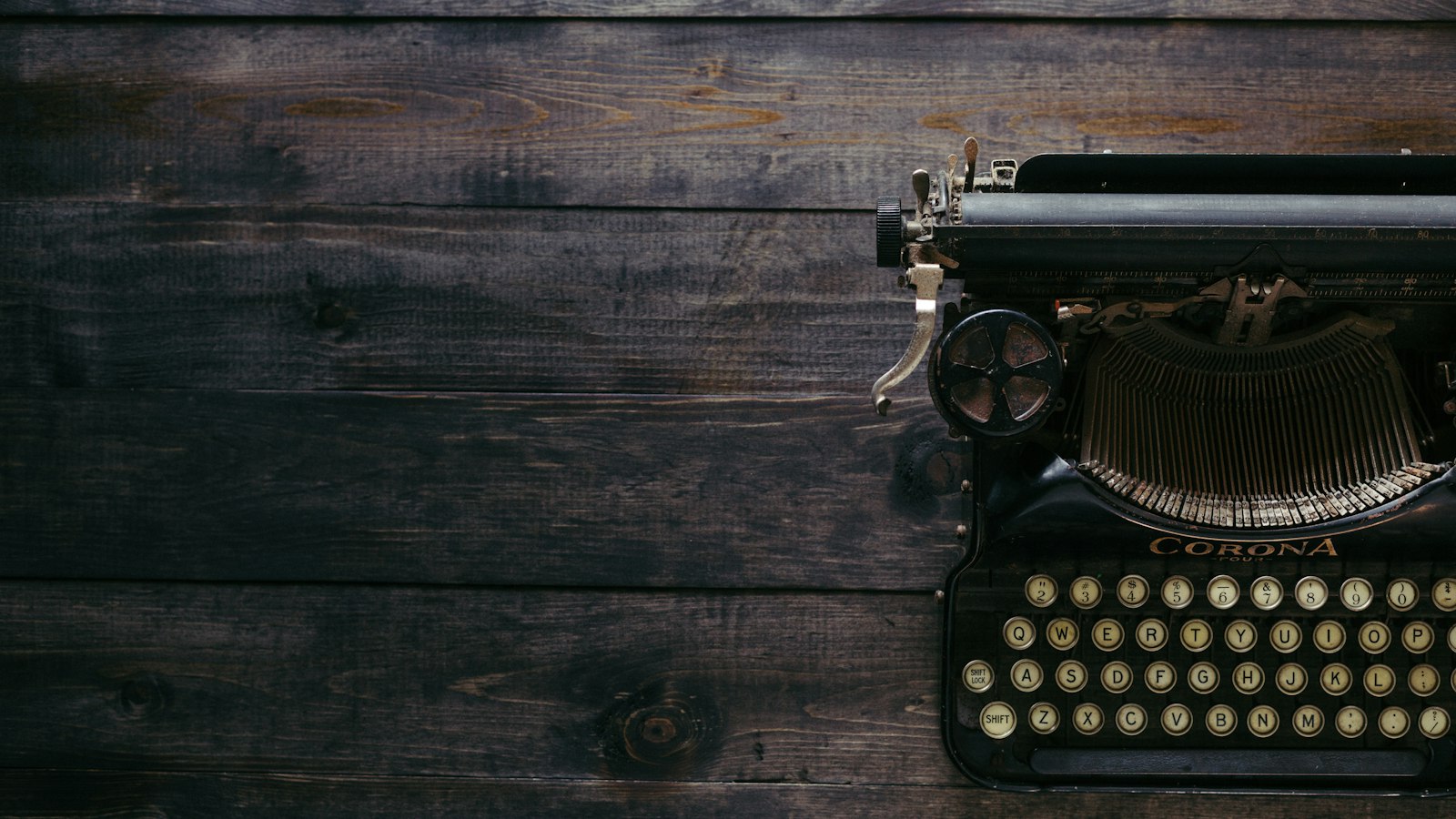 black Corona typewriter on brown wood planks