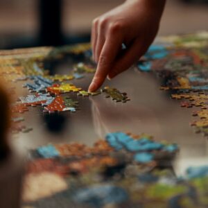 person holding jigsaw puzzle piece