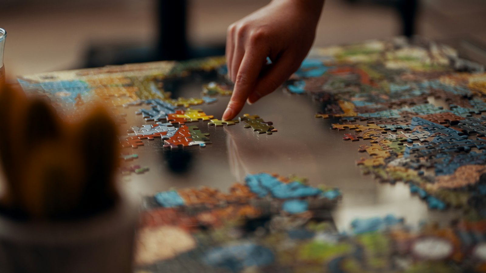 person holding jigsaw puzzle piece