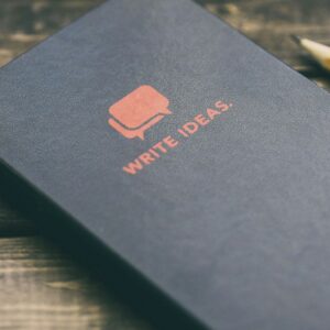 Write Ideas book on brown wooden board