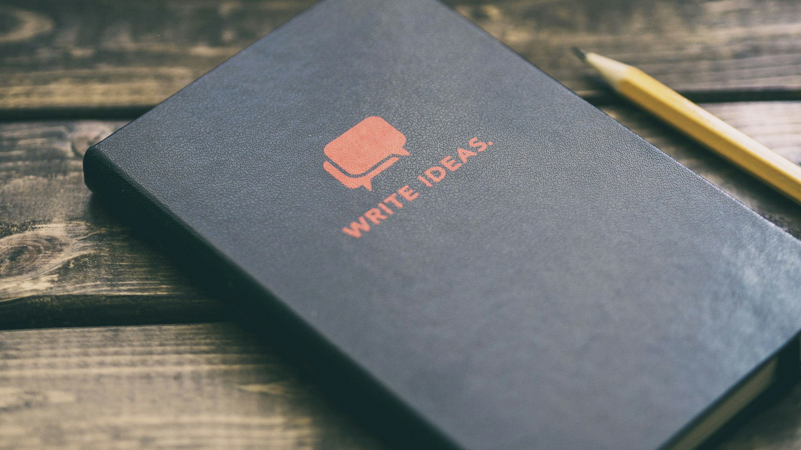Write Ideas book on brown wooden board