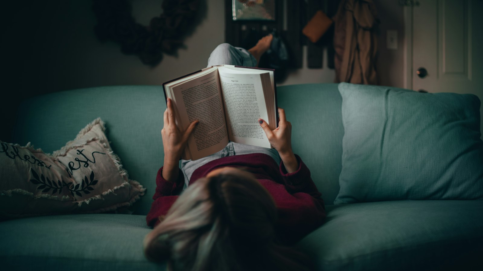 woman in red shirt reading book