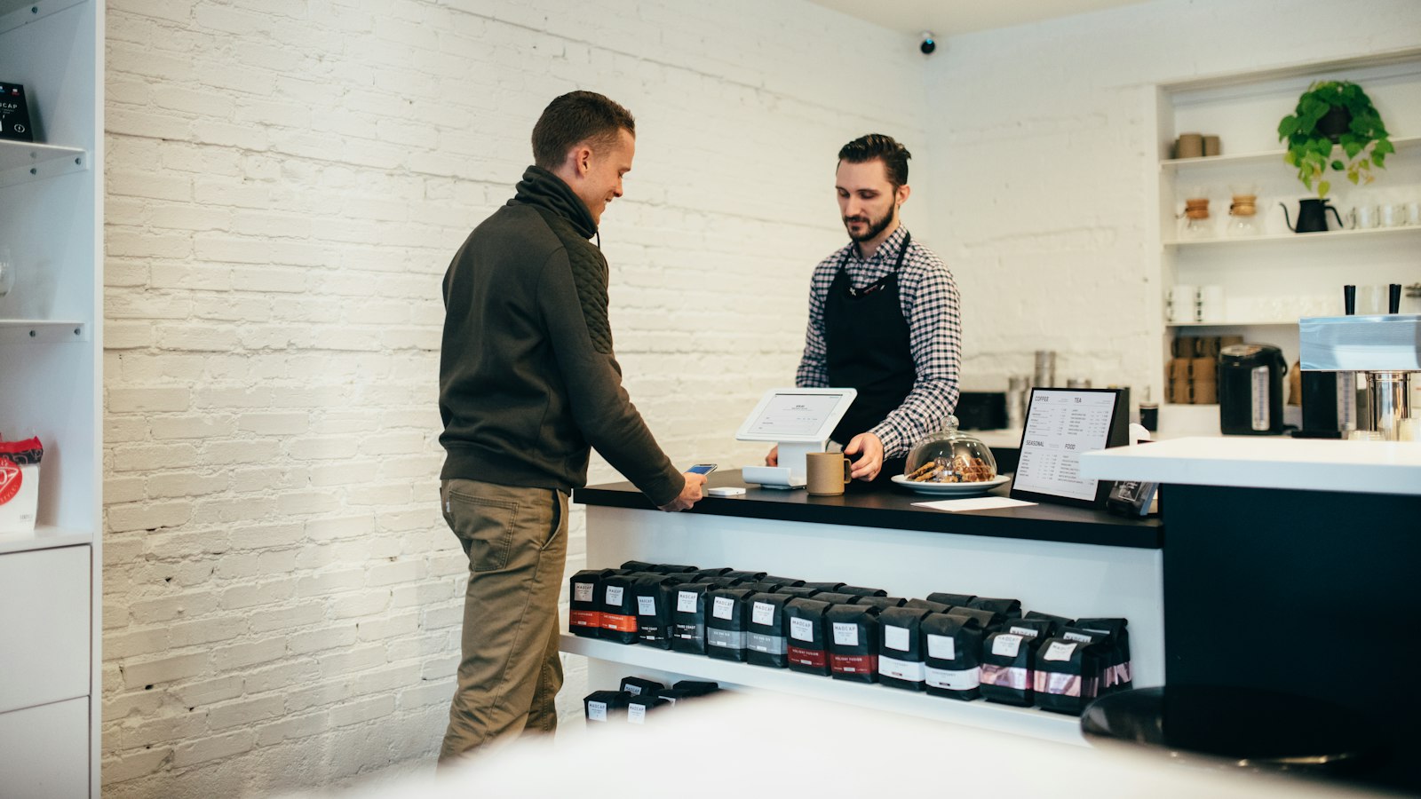 man buying item in shop