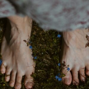 persons feet on green grass