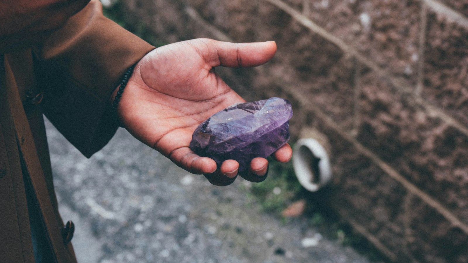 person holding black stone fragment
