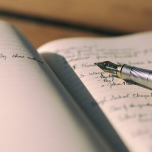 pen on white lined paper selective focus photography