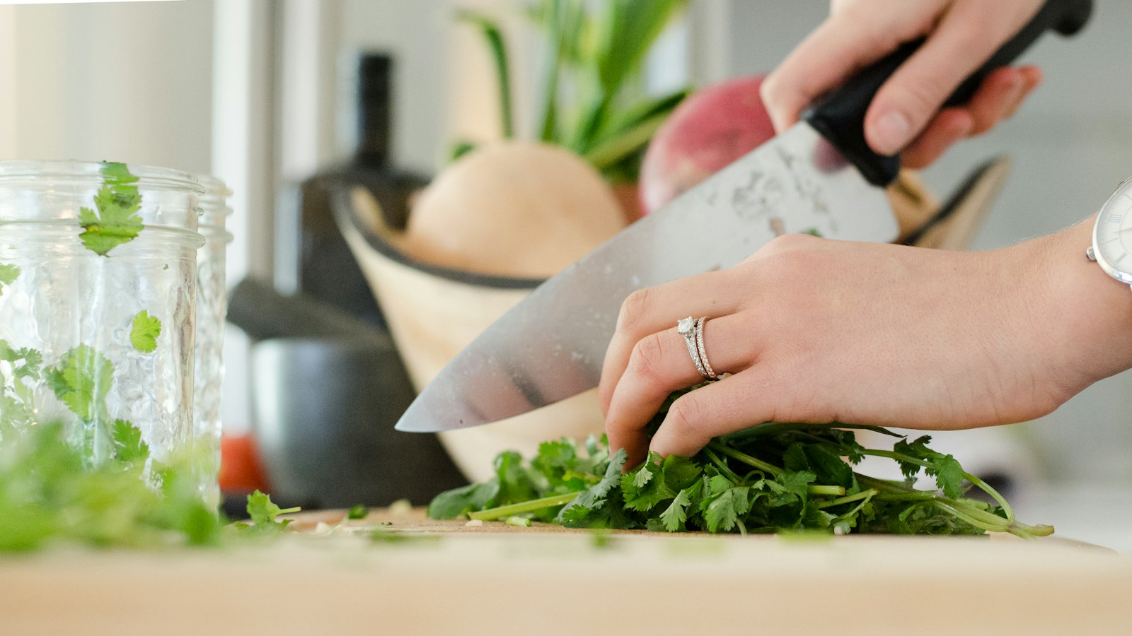 person cutting vegetables with knife