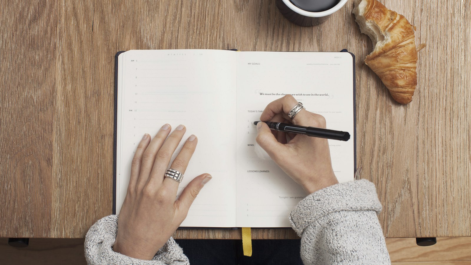 person writing on a book