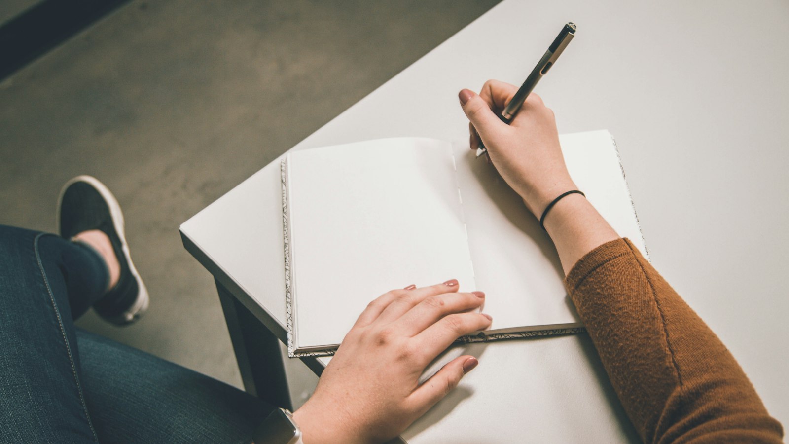 person writing on white paper