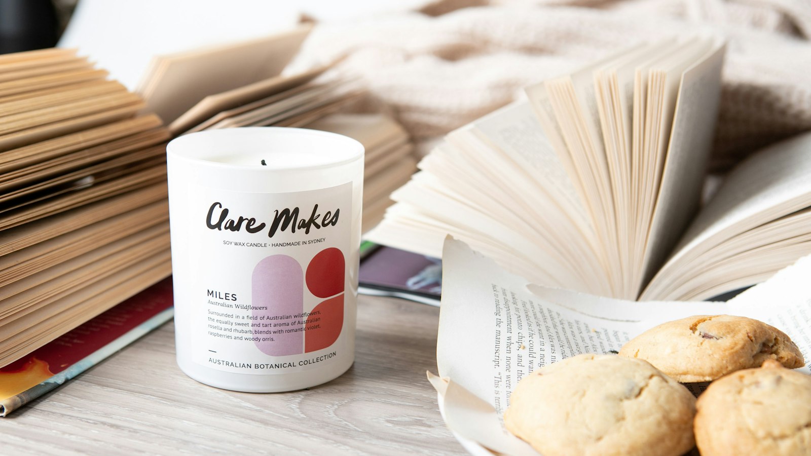 a stack of books sitting next to a plate of cookies