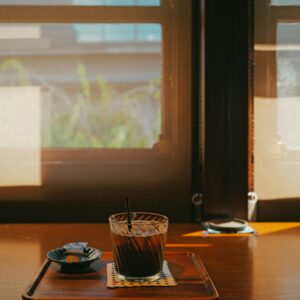 Iced coffee on a wooden table near window