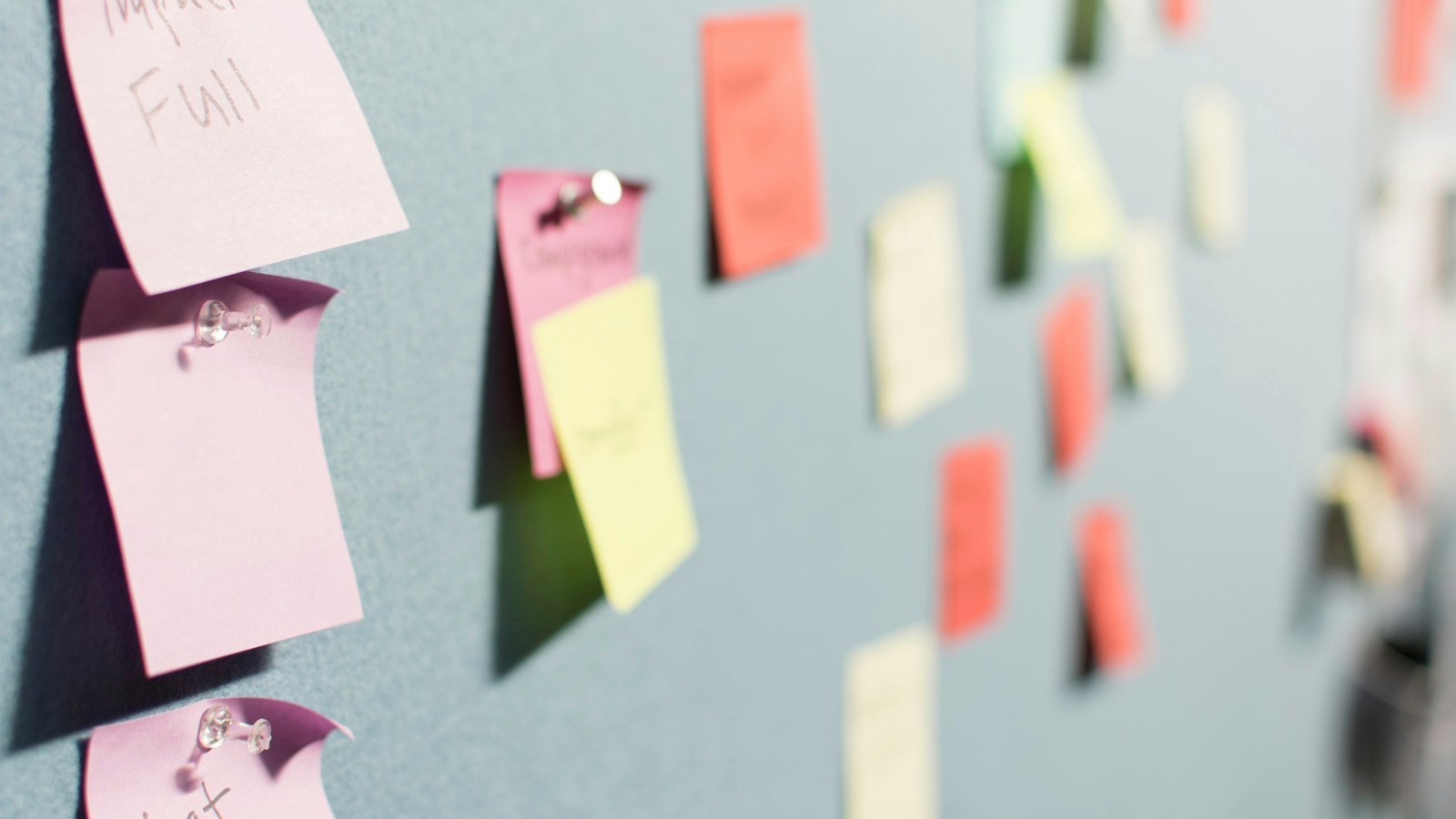 colorful sticky notes pinned to board