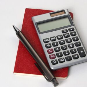 black and silver calculator beside black pen