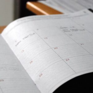 open monthly planner on wooden desk