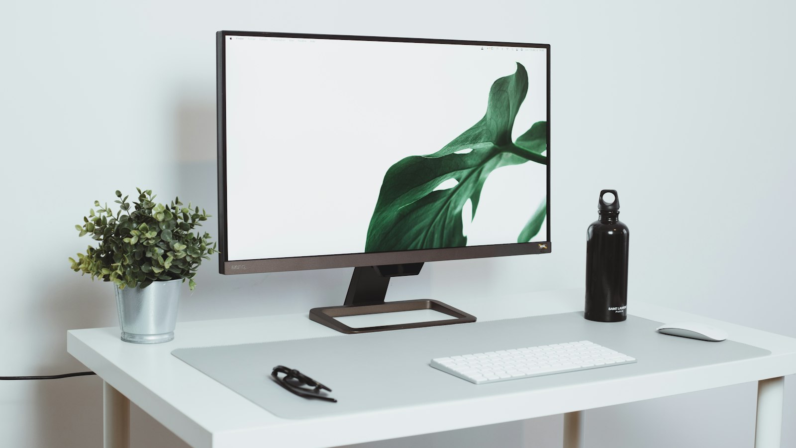a computer monitor sitting on top of a white desk