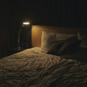 table lamp turned-on near bed