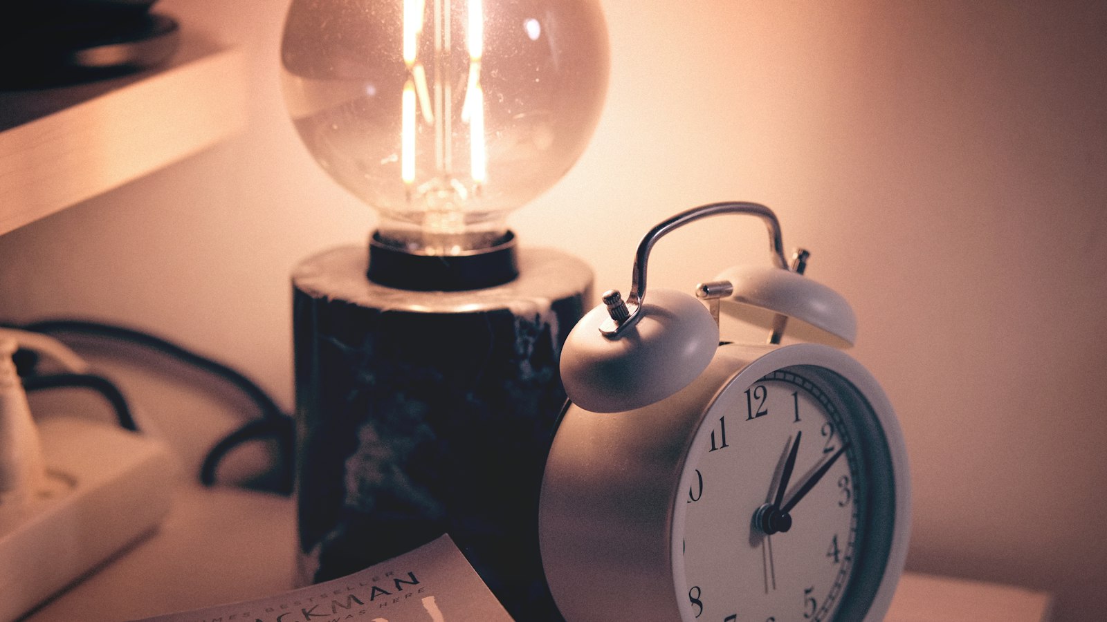 a clock and a lamp on a table