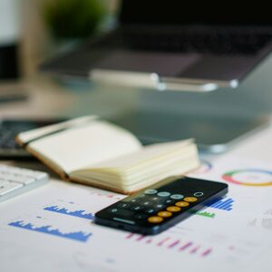 office desk with smartphone and financial charts