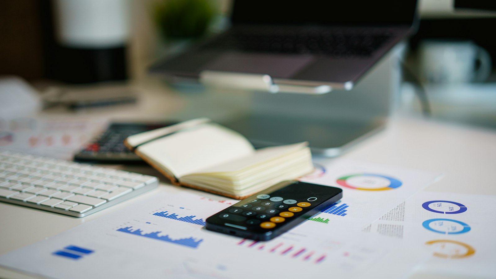 office desk with smartphone and financial charts