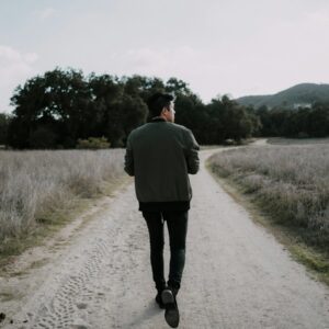 man walking on empty road