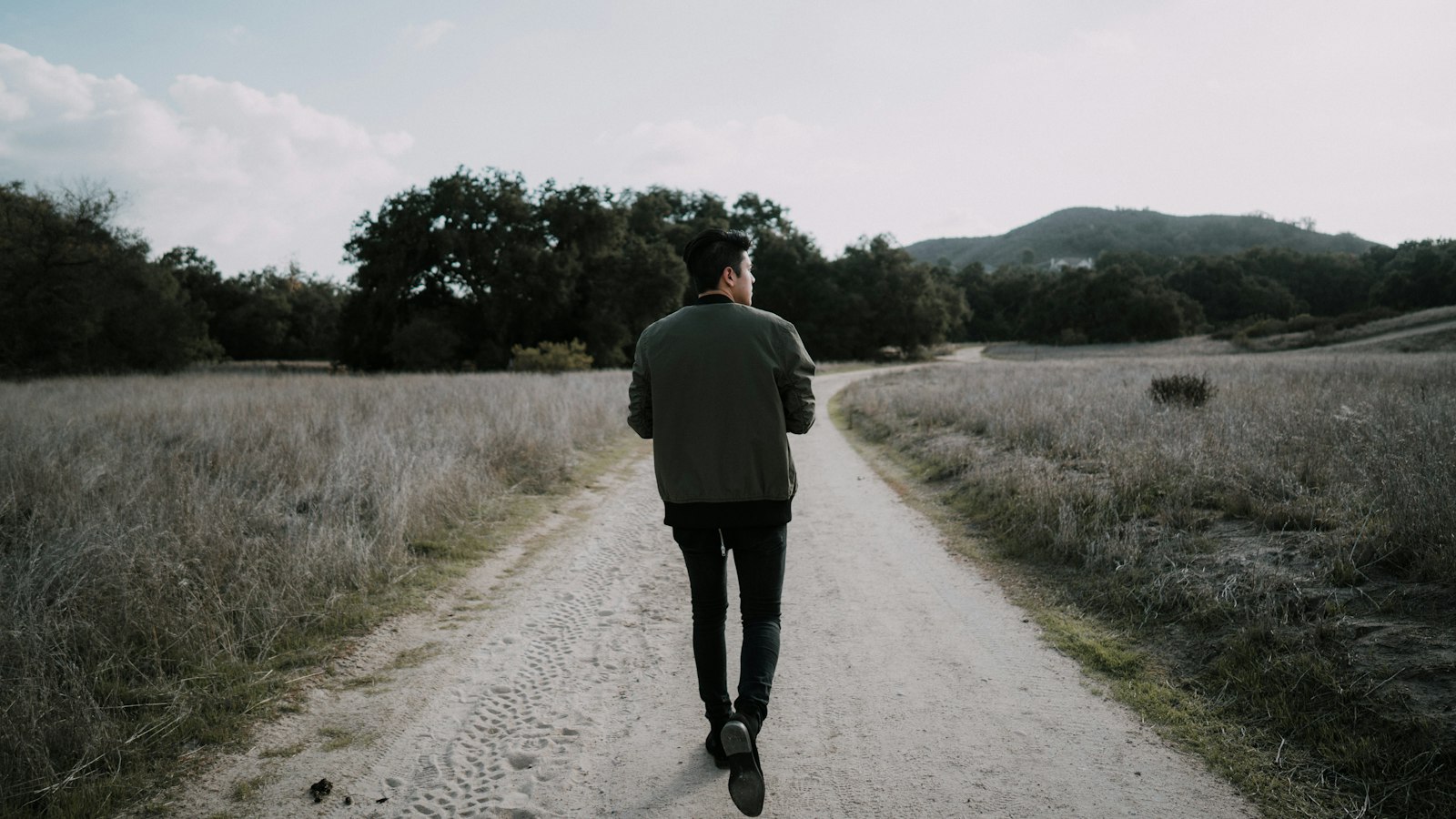 man walking on empty road
