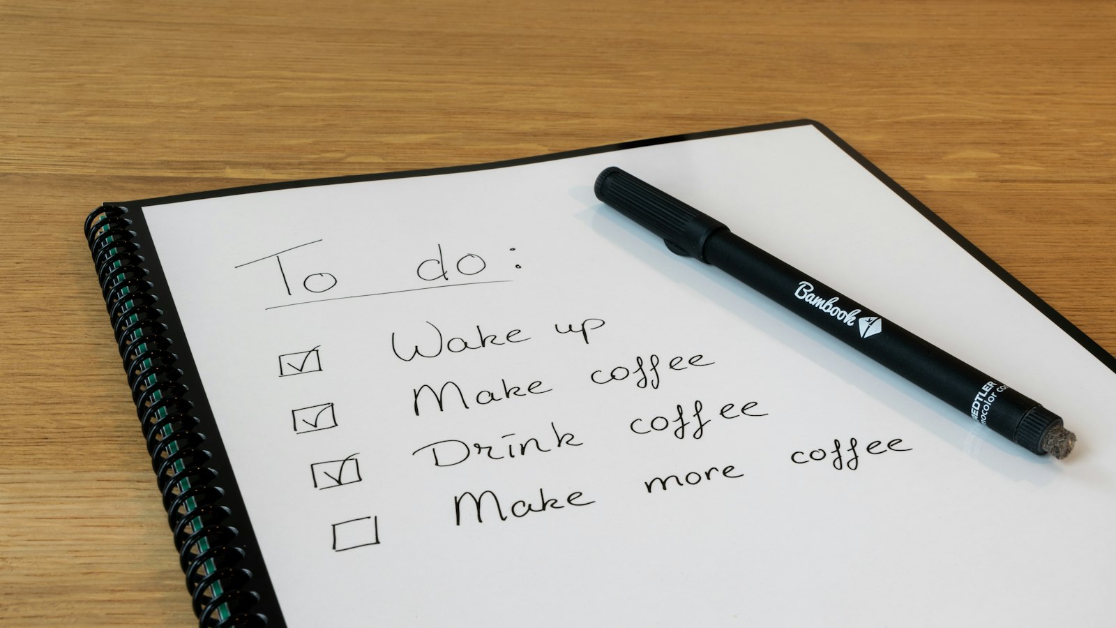 a notepad with a pen on top of it