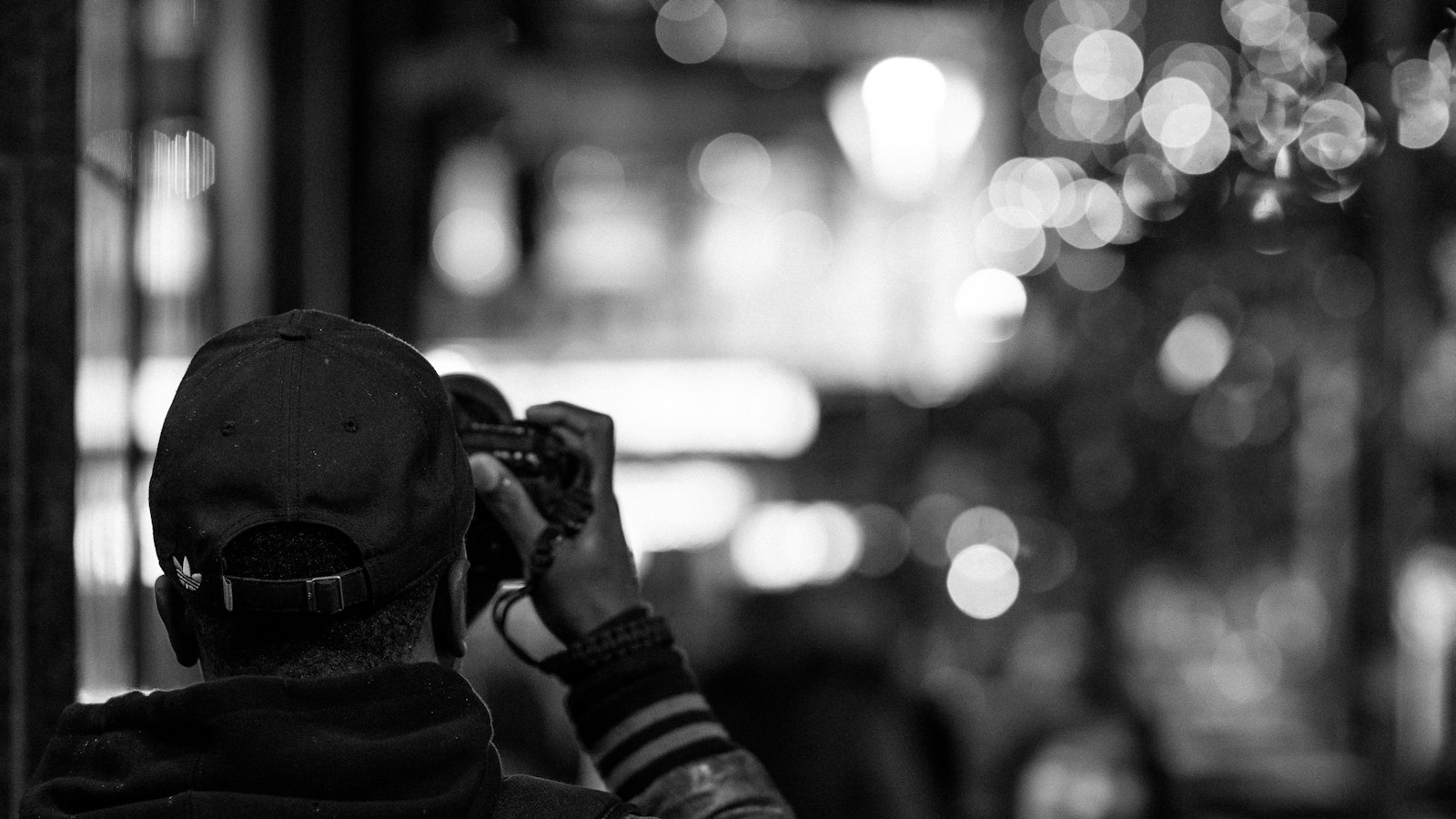 a black and white photo of a man talking on a cell phone