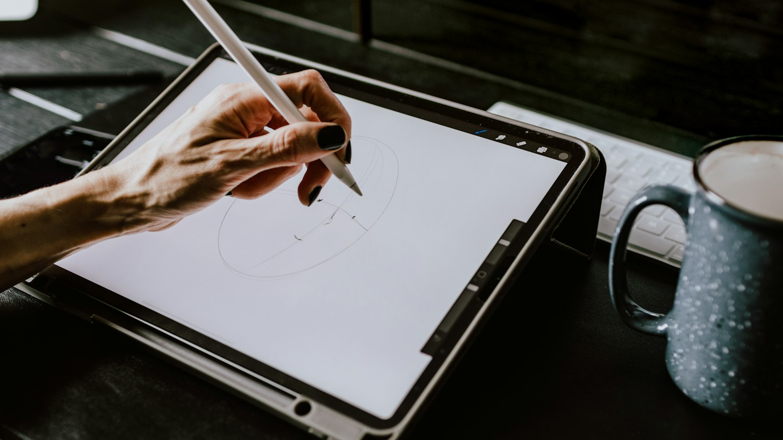 person holding white ipad with black case