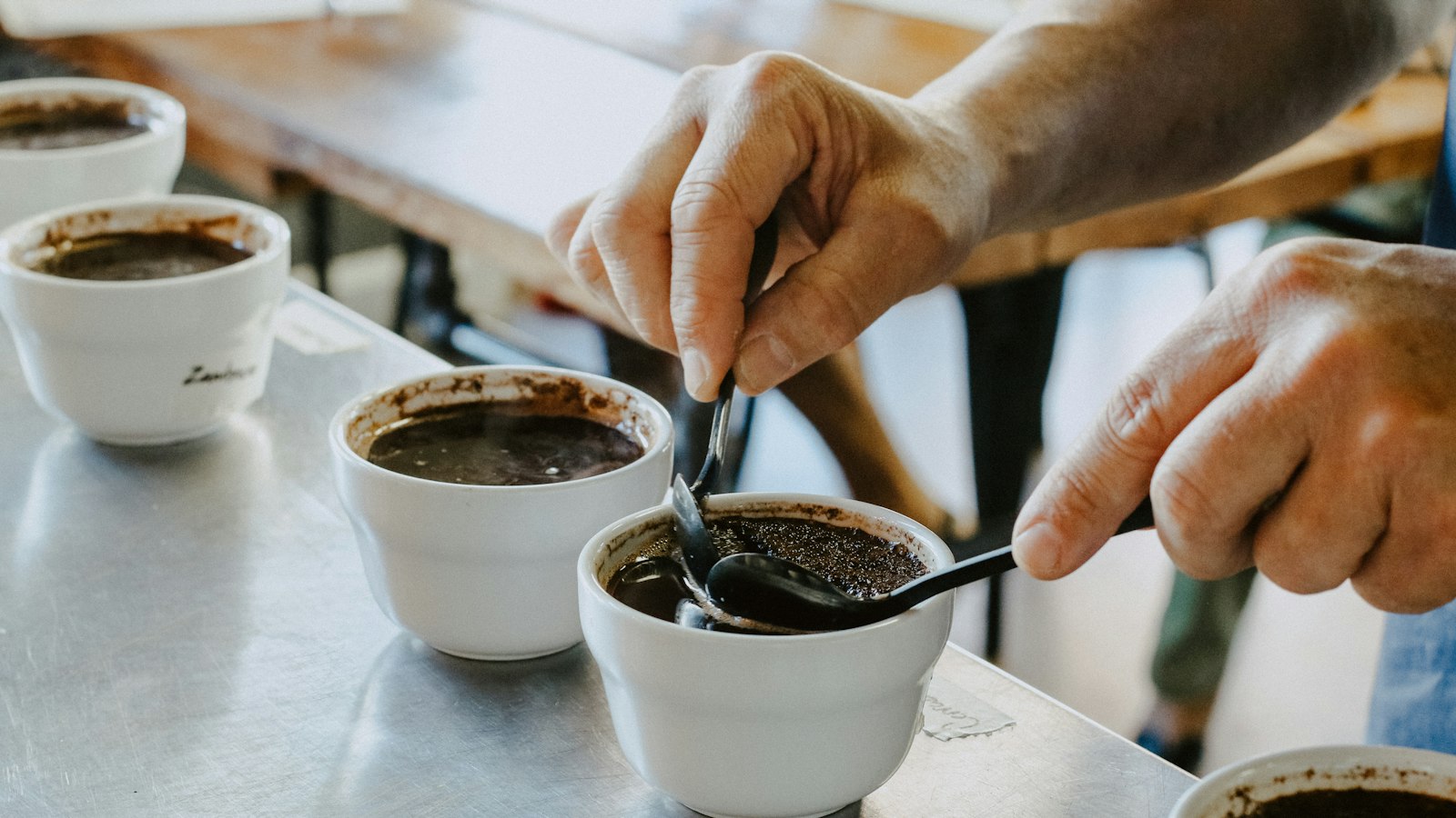 person mixing black coffee