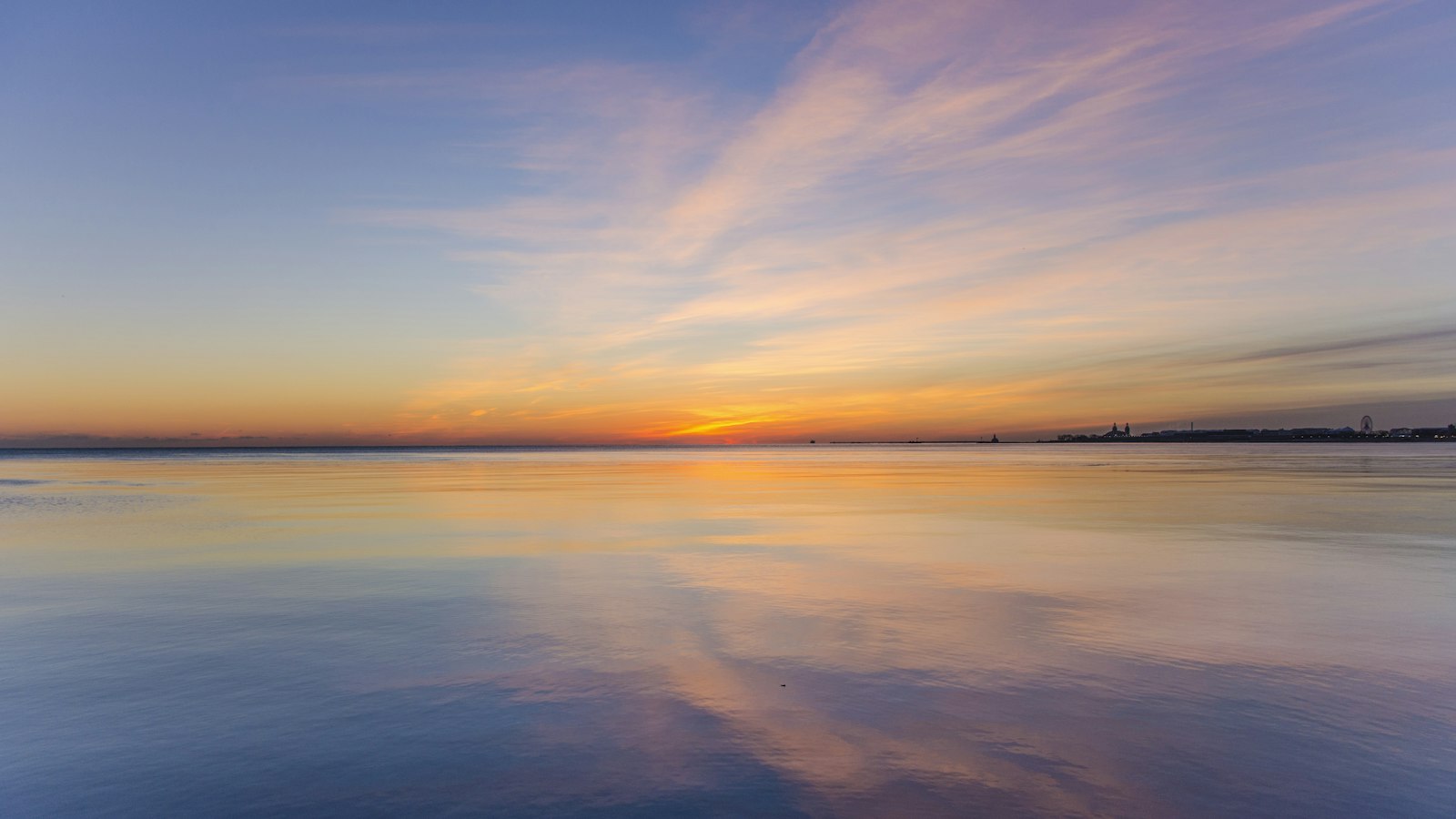 body of water under cloudy sky