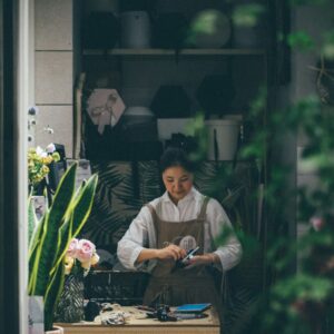 woman standing beside the table