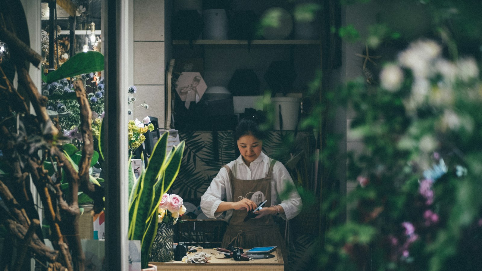 woman standing beside the table