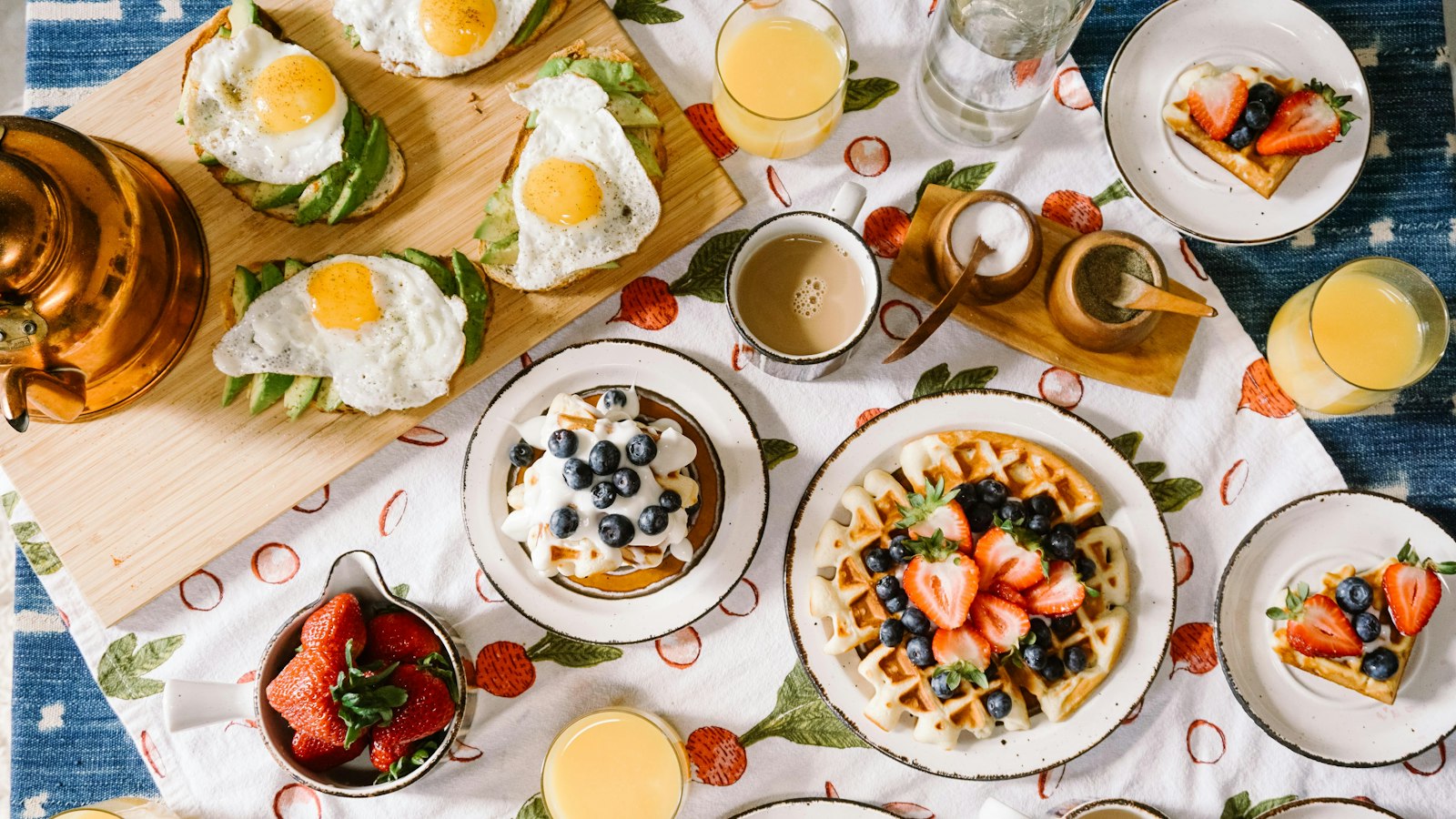 breakfast spread with waffles eggs and juice