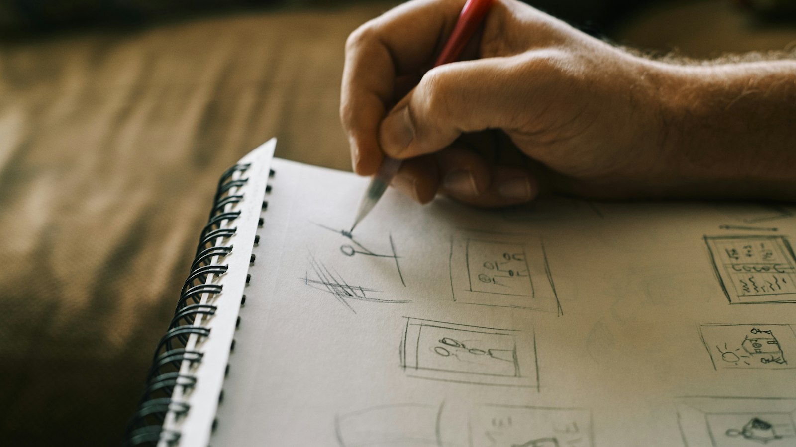 person writing on white notebook